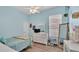 Cozy bedroom with ceiling fan, natural light, and warm blue walls at 308 Kissengen Park Dr, Bartow, FL 33830