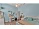 Comfortable bedroom featuring a ceiling fan and a charming desk and bed at 308 Kissengen Park Dr, Bartow, FL 33830