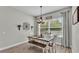Bright dining room with a rustic table, chandelier lighting, and a large window offering natural light at 308 Kissengen Park Dr, Bartow, FL 33830