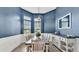 Charming dining room with blue walls, wainscoting, and a rustic wood table at 308 Kissengen Park Dr, Bartow, FL 33830