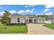 Charming single-story home features a well-manicured lawn, fresh landscaping, and neutral stucco exterior at 308 Kissengen Park Dr, Bartow, FL 33830