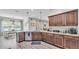 Spacious kitchen with granite counters, dark wood cabinets, and a view of the dining and living area at 308 Kissengen Park Dr, Bartow, FL 33830