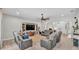 Comfortable living room with a large TV, ceiling fan, and ample seating, perfect for entertaining guests or relaxing with Gathering at 308 Kissengen Park Dr, Bartow, FL 33830