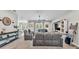 Open-concept living room with plush seating, ceiling fan, and access to the backyard at 308 Kissengen Park Dr, Bartow, FL 33830