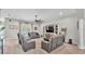 Spacious living room with neutral tones, ceiling fan, and built-in shelving at 308 Kissengen Park Dr, Bartow, FL 33830