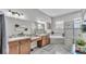 Main bathroom featuring double sink vanity, bathtub and a glass enclosed shower at 308 Kissengen Park Dr, Bartow, FL 33830