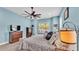 King bed with large wall mounted TV, ceiling fan, carpet and a window view at 308 Kissengen Park Dr, Bartow, FL 33830
