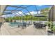Relaxing screened pool area with table, chairs, and lush greenery for outdoor entertainment and leisure at 308 Kissengen Park Dr, Bartow, FL 33830