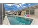Sparkling screened pool offers refreshing relaxation with clear blue water and ample space for outdoor entertainment at 308 Kissengen Park Dr, Bartow, FL 33830