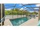 A gorgeous screened pool offers refreshing relaxation with clear blue water and ample space for a cool swim at 308 Kissengen Park Dr, Bartow, FL 33830