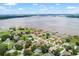 Waterfront community with private docks extending into the lake, surrounded by homes and greenery at 328 Hamilton Shores Ne Dr, Winter Haven, FL 33881