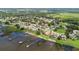 Community aerial view showcases a lakefront setting with numerous homes and private docks at 328 Hamilton Shores Ne Dr, Winter Haven, FL 33881