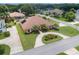 Stunning aerial view of a home with mature landscaping and a circular driveway at 328 Hamilton Shores Ne Dr, Winter Haven, FL 33881