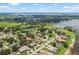 Expansive aerial shot of a lakeside town featuring homes, lush greenery, and blue waters at 328 Hamilton Shores Ne Dr, Winter Haven, FL 33881