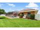 Expansive lawn leads to a screened pool area, perfect for relaxation and outdoor activities at 328 Hamilton Shores Ne Dr, Winter Haven, FL 33881