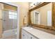 Bathroom with a framed mirror, white cabinets, and a shower-tub combination at 328 Hamilton Shores Ne Dr, Winter Haven, FL 33881