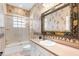 Charming bathroom with vintage wallpaper, a framed mirror, and a shower-tub combination at 328 Hamilton Shores Ne Dr, Winter Haven, FL 33881