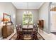 Elegant dining room with a chandelier, large windows, and a decorative rug at 328 Hamilton Shores Ne Dr, Winter Haven, FL 33881