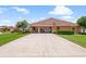 Long driveway leads to a home with a spacious three-car garage and well-maintained landscaping at 328 Hamilton Shores Ne Dr, Winter Haven, FL 33881