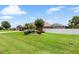 Manicured lawn complements this home's exterior, complete with screened-in pool and landscaping at 328 Hamilton Shores Ne Dr, Winter Haven, FL 33881