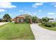 Inviting single-story home featuring lush lawn, mature trees, and circular driveway at 328 Hamilton Shores Ne Dr, Winter Haven, FL 33881