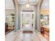 Elegant foyer featuring tile flooring, arched doorways and a decorative lighting fixture at 328 Hamilton Shores Ne Dr, Winter Haven, FL 33881