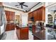 Gourmet kitchen with stainless steel appliances, dark wood cabinets, and mosaic backsplash at 328 Hamilton Shores Ne Dr, Winter Haven, FL 33881