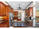 Modern kitchen featuring stainless steel appliances, dark wood cabinets, and granite countertops at 328 Hamilton Shores Ne Dr, Winter Haven, FL 33881