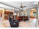 Cozy living room showcasing a leather recliner and connections to the kitchen and foyer at 328 Hamilton Shores Ne Dr, Winter Haven, FL 33881