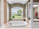 Beautiful bathroom featuring large soaking tub, dual sinks and natural light at 328 Hamilton Shores Ne Dr, Winter Haven, FL 33881