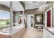 Stylish bathroom features walk-in closet, soaking tub, and dual sinks at 328 Hamilton Shores Ne Dr, Winter Haven, FL 33881