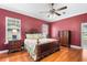 Spacious main bedroom with hardwood floors, king bed, ceiling fan and matching nightstands at 328 Hamilton Shores Ne Dr, Winter Haven, FL 33881