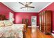 Main bedroom boasts hardwood floors, ceiling fan, and access to the ensuite bathroom at 328 Hamilton Shores Ne Dr, Winter Haven, FL 33881