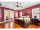 Cozy main bedroom features hardwood floors, natural light and direct access to the lanai at 328 Hamilton Shores Ne Dr, Winter Haven, FL 33881