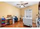 Functional office space featuring hardwood floors, work surfaces, and a ceiling fan at 328 Hamilton Shores Ne Dr, Winter Haven, FL 33881