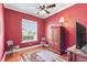 Bright office space with red walls, a window, and a wooden cabinet at 328 Hamilton Shores Ne Dr, Winter Haven, FL 33881