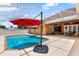 Enjoy the screened pool with an outdoor patio and multiple umbrellas for shade at 328 Hamilton Shores Ne Dr, Winter Haven, FL 33881