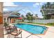 Inviting screened pool with patio and seating area offers a private outdoor oasis at 328 Hamilton Shores Ne Dr, Winter Haven, FL 33881