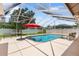 Refreshing screened-in pool with patio and umbrella offers a relaxing outdoor space at 328 Hamilton Shores Ne Dr, Winter Haven, FL 33881