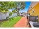 A spacious backyard featuring healthy lawn with a large tree providing ample shade at 345 Avenue J Se, Winter Haven, FL 33880