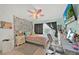 Comfortable bedroom featuring unique decorations, a ceiling fan, and a dedicated workspace at 345 Avenue J Se, Winter Haven, FL 33880