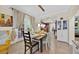 Inviting dining room with a view to the kitchen and bright, natural light streaming through the windows at 345 Avenue J Se, Winter Haven, FL 33880