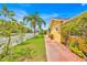 Quaint yellow home with a white picket fence and lush greenery along the side of the property at 345 Avenue J Se, Winter Haven, FL 33880