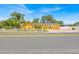 Yellow home with white picket fence and long driveway, showcasing curb appeal and a neatly maintained exterior at 345 Avenue J Se, Winter Haven, FL 33880