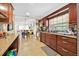 Spacious kitchen with stainless steel appliances, granite countertops, and tile floors flowing into the dining area at 345 Avenue J Se, Winter Haven, FL 33880