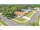 Aerial view of home on a corner lot, showcasing the manicured lawn, mature trees, and proximity to the community lake at 3717 Tigereye Ct, Mulberry, FL 33860