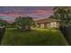 Expansive fenced backyard, features lush lawn and mature trees, providing a serene and private outdoor space at 3717 Tigereye Ct, Mulberry, FL 33860