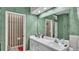 Bathroom with double sinks, white cabinetry, and wallpapered WC at 3717 Tigereye Ct, Mulberry, FL 33860