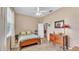 Inviting bedroom with a ceiling fan, a dresser, and a window providing natural light at 3717 Tigereye Ct, Mulberry, FL 33860