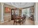 Elegant dining room boasts a stylish chandelier, wainscoting, and a large window offering ample natural light at 3717 Tigereye Ct, Mulberry, FL 33860